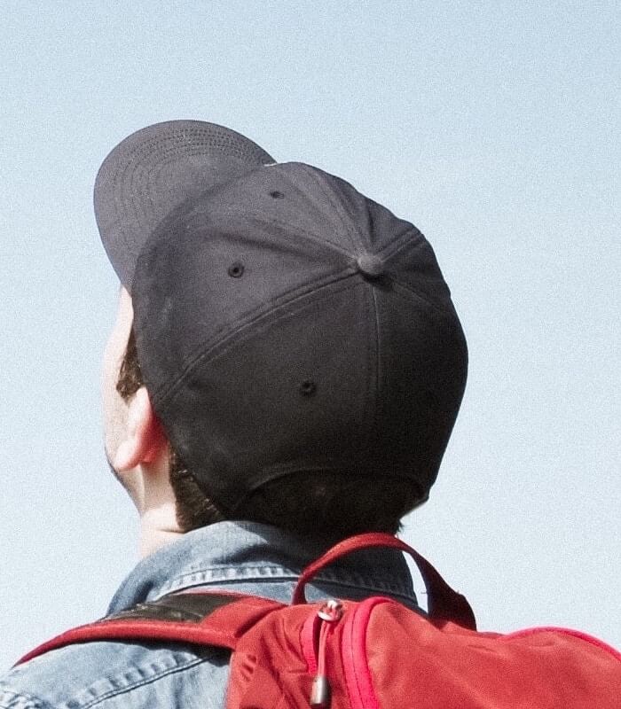 Young male student overlooking city street.